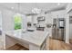 Bright kitchen with white cabinets, stainless steel appliances, and quartz countertops at 3755 Valleyway Rd, Cumming, GA 30040