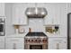 Close-up of a stainless steel range and white cabinets in modern kitchen at 3755 Valleyway Rd, Cumming, GA 30040