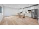 Spacious kitchen features white cabinetry, stainless appliances, and hardwood flooring at 3755 Valleyway Rd, Cumming, GA 30040