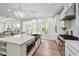 Modern white kitchen with quartz countertops, stainless appliances, and wood floors offers style and functionality at 3755 Valleyway Rd, Cumming, GA 30040