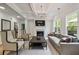 Cozy living room with a fireplace, coffered ceilings, hardwood floors, and large windows at 3755 Valleyway Rd, Cumming, GA 30040