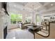 Open concept living area with fireplace, hardwood floors, and a view to the backyard at 3755 Valleyway Rd, Cumming, GA 30040