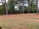 Large backyard featuring mature trees at 499 Oak Way, Lawrenceville, GA 30046
