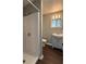 Updated bathroom featuring a walk-in shower, modern vanity, and fresh fixtures, offering a comfortable and functional space at 499 Oak Way, Lawrenceville, GA 30046