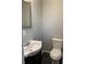 Cozy half-bathroom featuring modern fixtures, tile flooring, and neutral paint at 499 Oak Way, Lawrenceville, GA 30046
