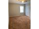 Spacious bedroom with soft carpet, natural light, and closet for ample storage at 499 Oak Way, Lawrenceville, GA 30046