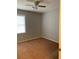 Bright bedroom with neutral walls, ceiling fan, large window and plush carpet at 499 Oak Way, Lawrenceville, GA 30046