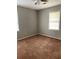 Carpeted bedroom with neutral walls and natural light from two large windows at 499 Oak Way, Lawrenceville, GA 30046