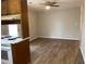 Open dining area with modern vinyl floors and a ceiling fan, located next to the kitchen at 499 Oak Way, Lawrenceville, GA 30046