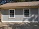 Close-up of the home's exterior showcasing gray wood siding, updated double-paned windows, and a clean, modern look at 499 Oak Way, Lawrenceville, GA 30046