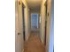Hallway showing neutral walls and carpet that leads to other rooms at 499 Oak Way, Lawrenceville, GA 30046