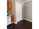 Compact kitchen area with wood cabinets, basic appliances, and vinyl flooring, designed for functionality in a cozy space at 499 Oak Way, Lawrenceville, GA 30046