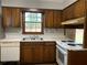 Functional kitchen with wooden cabinets, white countertops, and appliances at 499 Oak Way, Lawrenceville, GA 30046