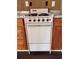 Close-up of the electric stove with wooden cabinets and granite-look countertop, ready for cooking and meal preparation at 499 Oak Way, Lawrenceville, GA 30046