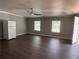 Bright living room with updated vinyl flooring, ceiling fan, and natural light, showcasing a clean, minimalist space at 499 Oak Way, Lawrenceville, GA 30046