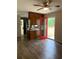 Open living area with wood floors, ceiling fan, and bright red door to the outside at 499 Oak Way, Lawrenceville, GA 30046
