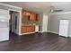 Open-concept living space with newer flooring, laundry closet, ceiling fan, and kitchen area with essential appliances at 499 Oak Way, Lawrenceville, GA 30046