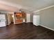 Open living area showcasing newer floors, a functional kitchen area, included appliances, and direct bathroom access at 499 Oak Way, Lawrenceville, GA 30046