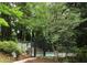View of the community pool with mature trees surrounding at 1131 Clairemont Ave # B, Decatur, GA 30030