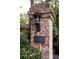 View of Emory Garden Condominiums sign with lantern on brick pillar surrounded by trees at 1131 Clairemont Ave # B, Decatur, GA 30030