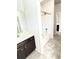Bathroom featuring a shower/tub combo, dark cabinets, and light gray walls at 2300 Ivy Birch Ln, Buford, GA 30519