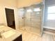 Bathroom featuring a glass enclosed shower with a bench and tiled walls and floor at 2300 Ivy Birch Ln, Buford, GA 30519
