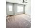 Bedroom with two windows, neutral carpet, ceiling fan, and light gray walls at 2300 Ivy Birch Ln, Buford, GA 30519