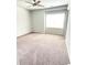 Spacious bedroom with neutral carpet, light gray walls, ceiling fan, and a large window for natural light at 2300 Ivy Birch Ln, Buford, GA 30519