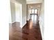 Elegant hallway with hardwood floors and decorative trim, leading to a bright living area at 2300 Ivy Birch Ln, Buford, GA 30519