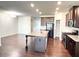 Well-lit kitchen features dark cabinets, stainless appliances, and granite countertops at 2300 Ivy Birch Ln, Buford, GA 30519