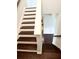 Stairway with white risers and stained treads lead to the upper level at 2300 Ivy Birch Ln, Buford, GA 30519