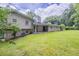 Expansive backyard featuring lush green grass and mature trees, ideal for outdoor activities at 3030 Golden Dr, Atlanta, GA 30344