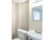 Cozy bathroom with a classic pedestal sink, toilet, and a mirrored vanity at 3030 Golden Dr, Atlanta, GA 30344