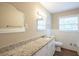 Bathroom featuring a granite countertop, decorative mirror, and white tile at 3030 Golden Dr, Atlanta, GA 30344