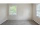 Cozy bedroom showcasing neutral walls and plush carpeting, illuminated by a window at 3030 Golden Dr, Atlanta, GA 30344