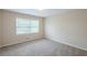Comfortable bedroom with neutral walls, plush carpet, and natural light from the large window at 3030 Golden Dr, Atlanta, GA 30344