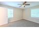Comfortable bedroom with neutral carpet, ceiling fan, and natural light from two windows at 3030 Golden Dr, Atlanta, GA 30344