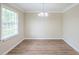 Bright dining room featuring vinyl flooring and a contemporary chandelier at 3030 Golden Dr, Atlanta, GA 30344