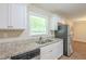 Galley kitchen features granite countertops, stainless steel appliances, and white cabinetry at 3030 Golden Dr, Atlanta, GA 30344