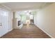 Spacious living room with a painted brick fireplace, and new vinyl flooring at 3030 Golden Dr, Atlanta, GA 30344