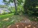 The home's large, grassy backyard features mature trees and privacy from neighboring properties at 1497 Elizabeth Ln, East Point, GA 30344
