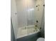 Bathroom with a shower featuring white subway tile, a glass shower door, and a chrome showerhead at 1497 Elizabeth Ln, East Point, GA 30344