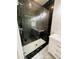 Luxurious bathroom featuring a glass-enclosed shower with dark marble and a dual-sink vanity with white cabinets at 1497 Elizabeth Ln, East Point, GA 30344