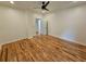 Inviting bedroom featuring hardwood floors, a ceiling fan, white walls, and an open doorway, creating a comfortable space at 1497 Elizabeth Ln, East Point, GA 30344