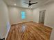 Spacious bedroom with hardwood floors, ample natural light from a window, and a ceiling fan for added comfort at 1497 Elizabeth Ln, East Point, GA 30344