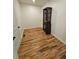 Well-organized walk-in closet with a wooden shelving unit and hardwood floors, maximizing storage space at 1497 Elizabeth Ln, East Point, GA 30344