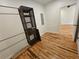Spacious walk-in closet featuring hardwood floors, metal racks and a custom shelving unit for optimal organization at 1497 Elizabeth Ln, East Point, GA 30344