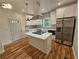 Modern kitchen with an island cooktop, stainless steel appliances, and white cabinets at 1497 Elizabeth Ln, East Point, GA 30344