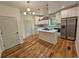 Modern kitchen with an island cooktop, stainless steel appliances, and white cabinets at 1497 Elizabeth Ln, East Point, GA 30344