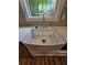 Close-up of a farmhouse-style kitchen sink with modern chrome fixtures and bright natural light at 1497 Elizabeth Ln, East Point, GA 30344
